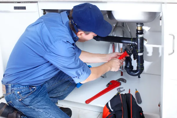 a male plumber fixing a toilet from Emergency Plumber Grand Prairie in Grand Prairie, TX a male plumber fixing a toilet from Emergency Plumber Grand Prairie in Grand Prairie, TX